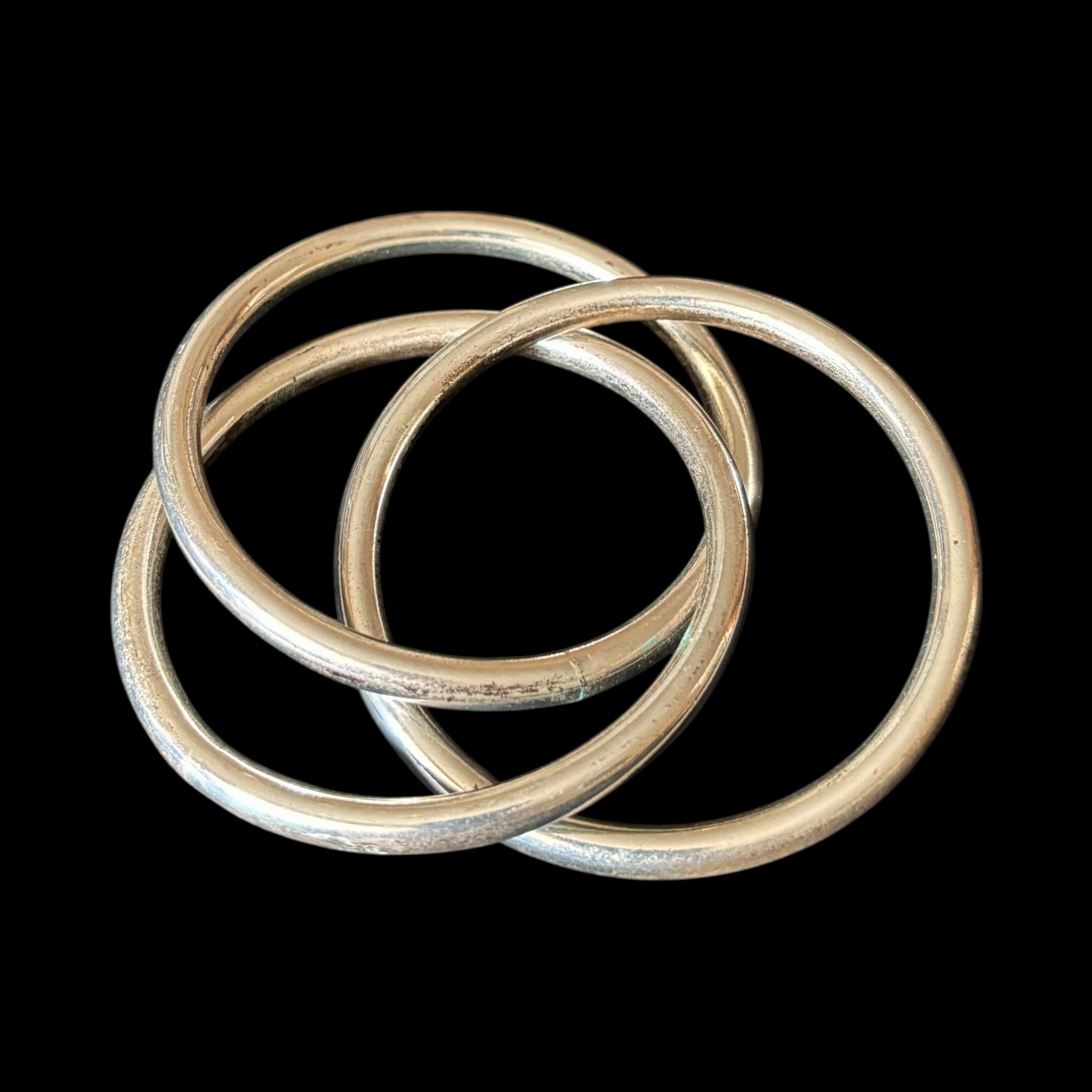 Three intertwined silver bangles
